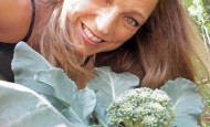 Shawna Coronado with broccoli in her front lawn veggie garden.