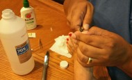 Luis removing a splinter Shawna Coronado's foot