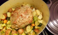 Herbed pork culinary dish made in a Le Creuset pan with vegetables.