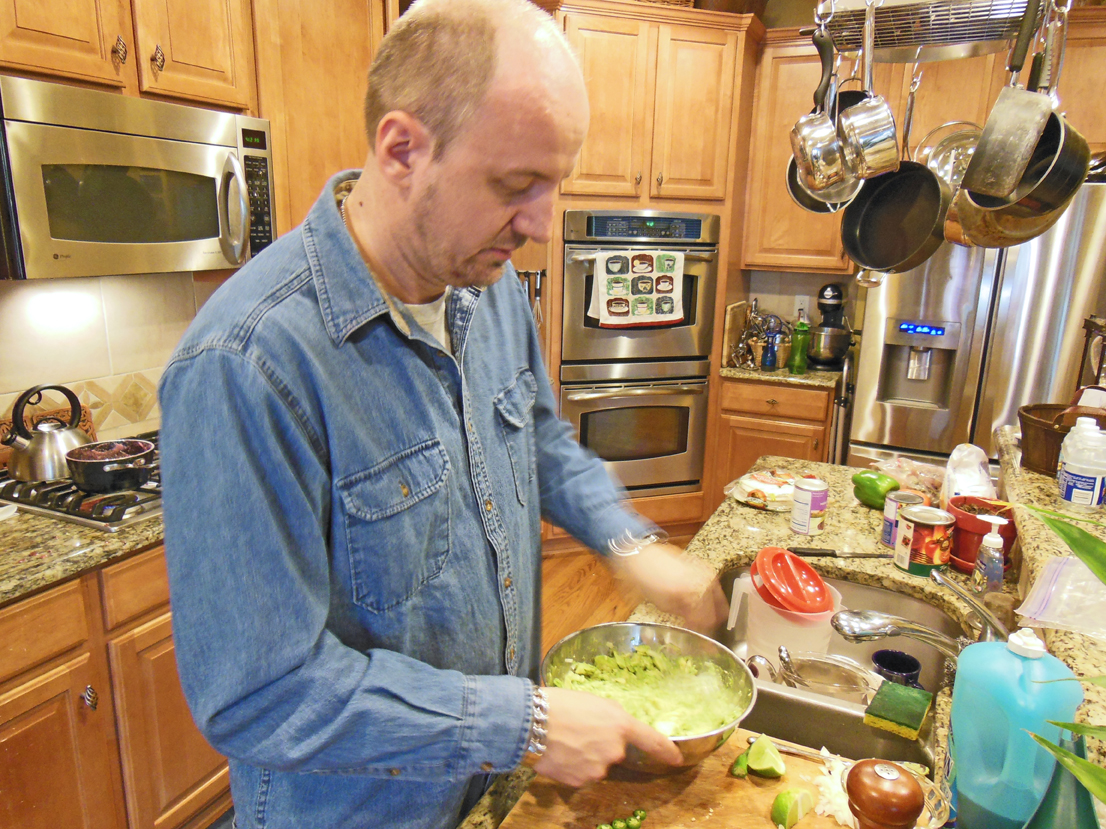 Michael Jenet cooking in his kitchen