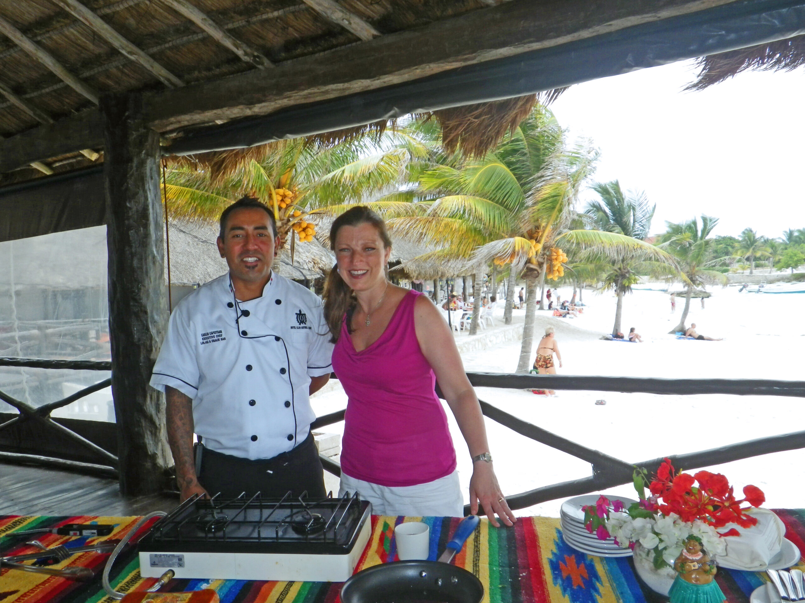 Chef Carlos and Shawna Coronado cooking on the beach